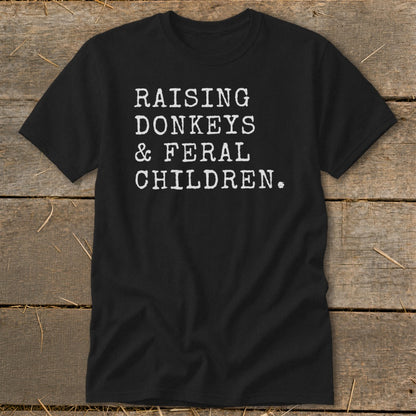 Black t-shirt with white text that reads "RAISING DONKEYS & FERAL CHILDREN."