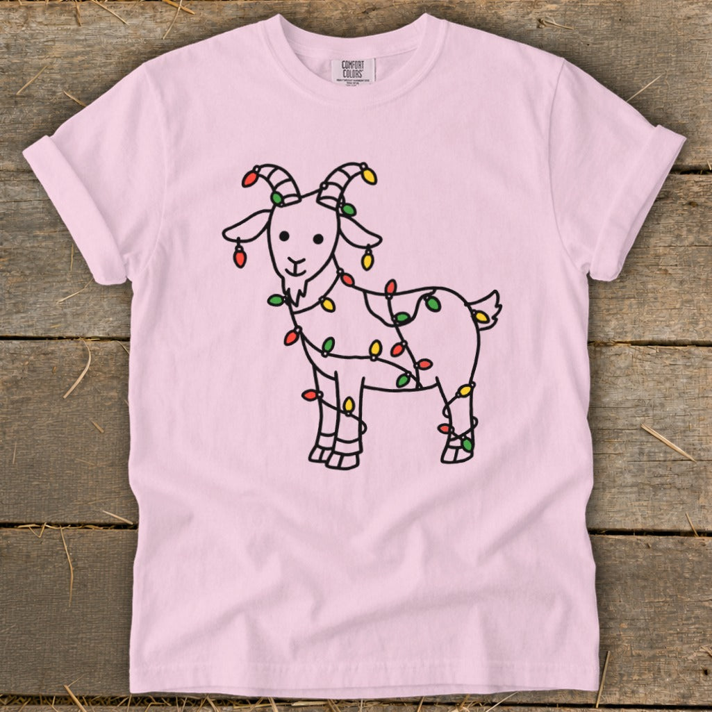 Pink t-shirt with a cartoon goat wrapped in colorful Christmas lights.