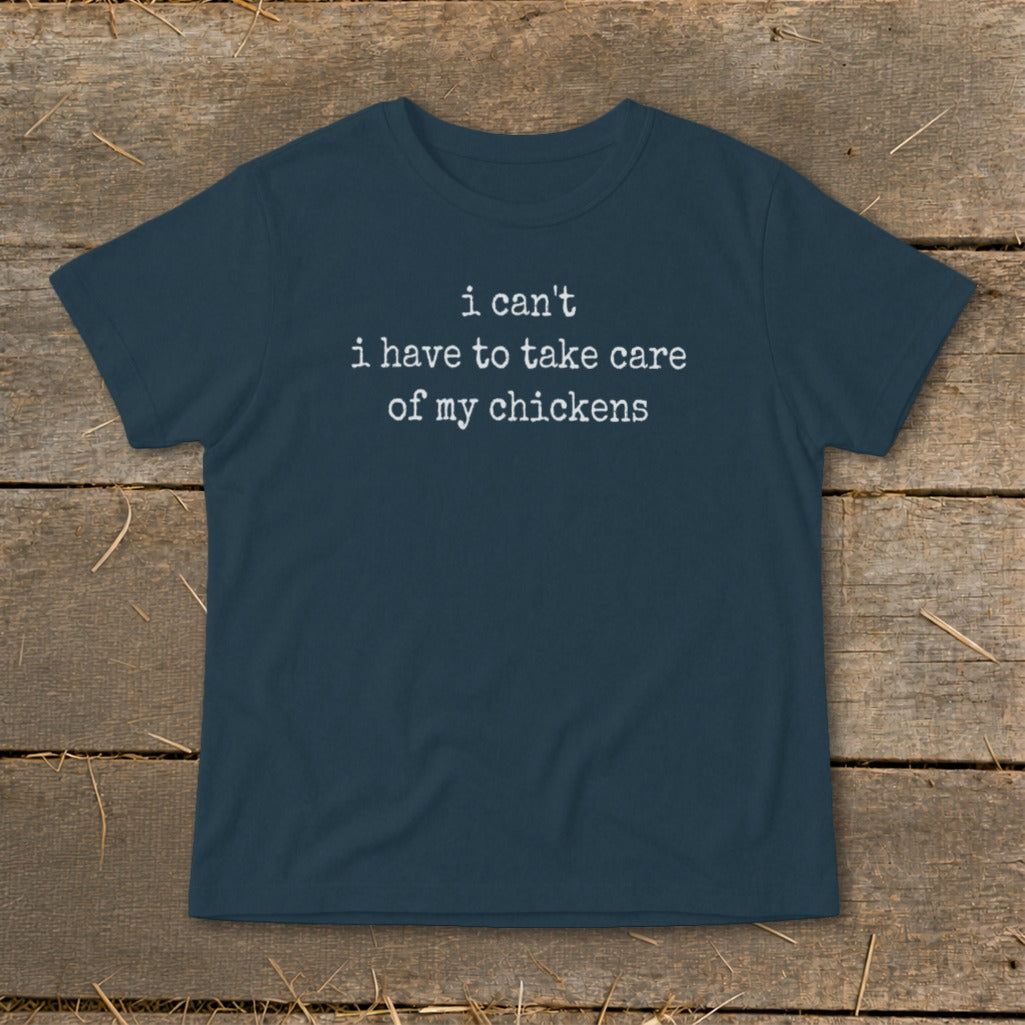 Dark blue t-shirt with white text: "i can't i have to take care of my chickens"