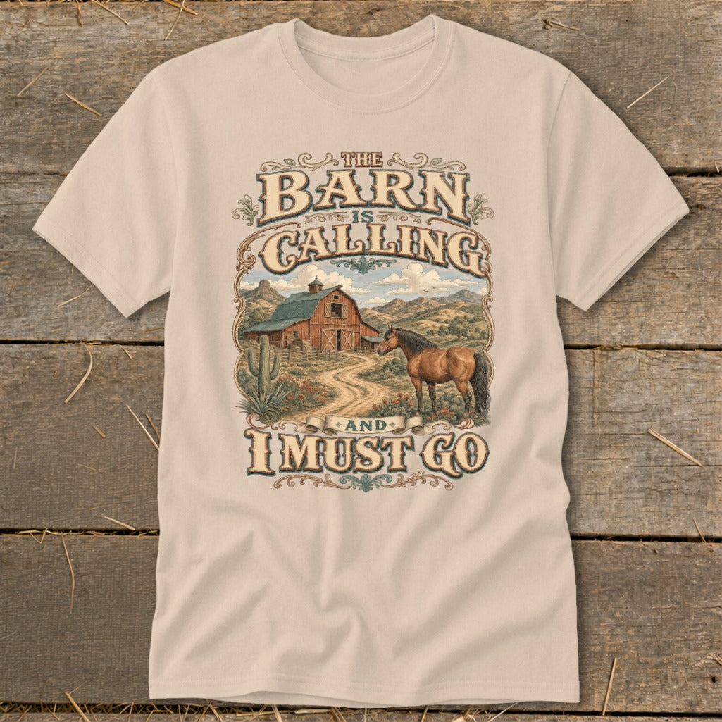 T-shirt graphic with text: The Barn is Calling and I Must Go, horse and barn scene.