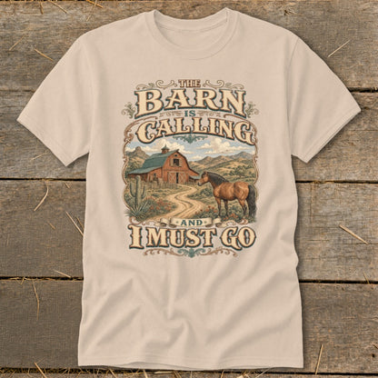 T-shirt graphic with text: The Barn is Calling and I Must Go, horse and barn scene.