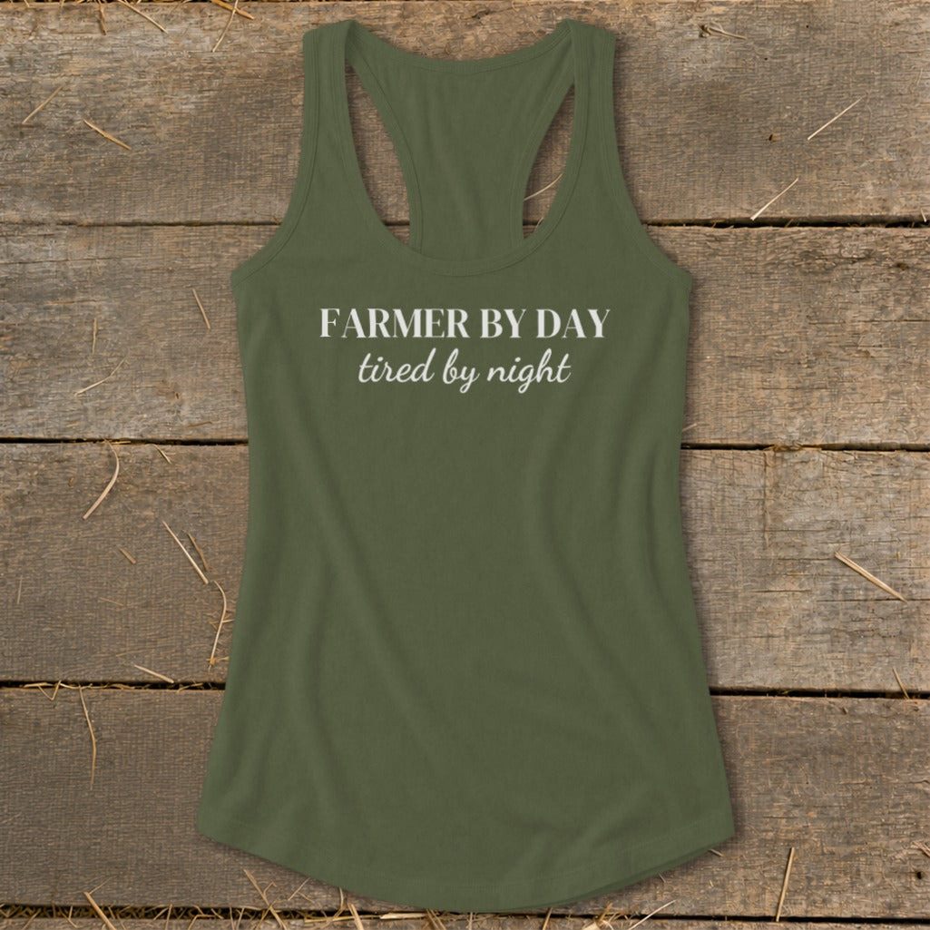 Green racerback tank top with white text reading "FARMER BY DAY tired by night."