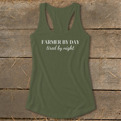 Green racerback tank top with white text reading "FARMER BY DAY tired by night."