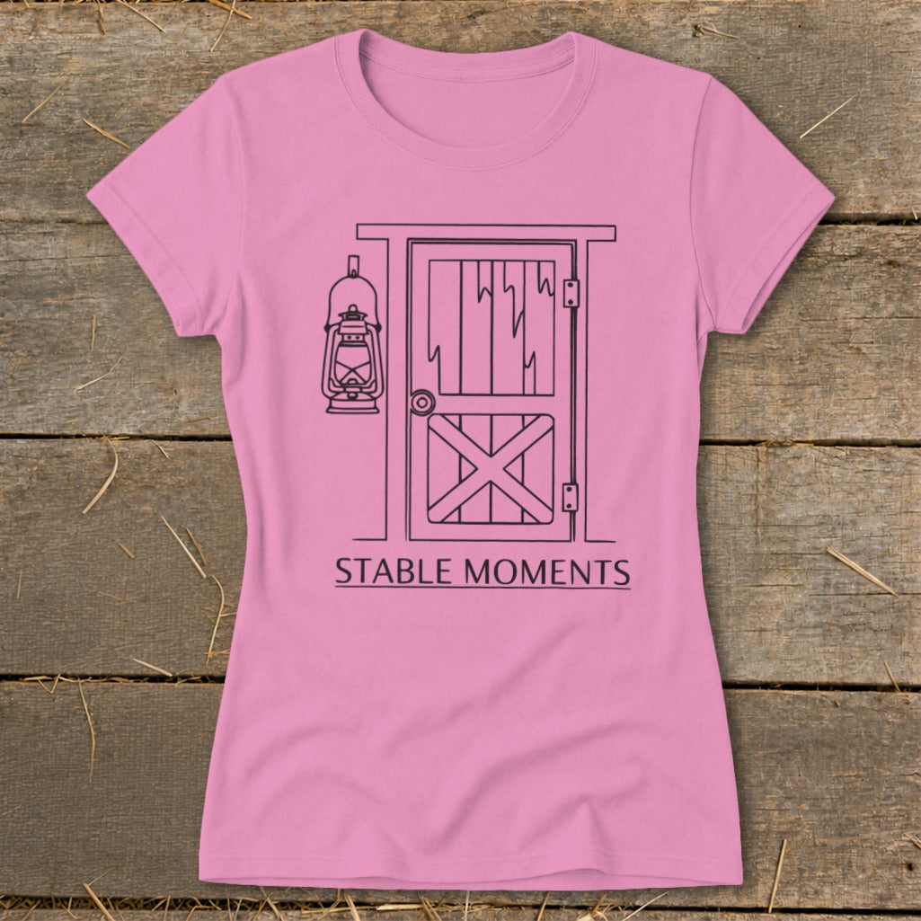 Pink t-shirt with barn door and lantern graphic and text "STABLE MOMENTS".