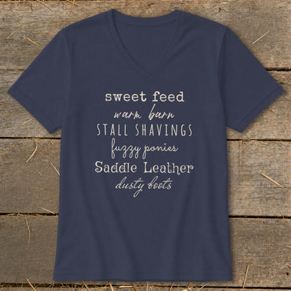 Navy v-neck t-shirt with text listing equestrian terms like sweet feed, warm barn, and dusty boots.