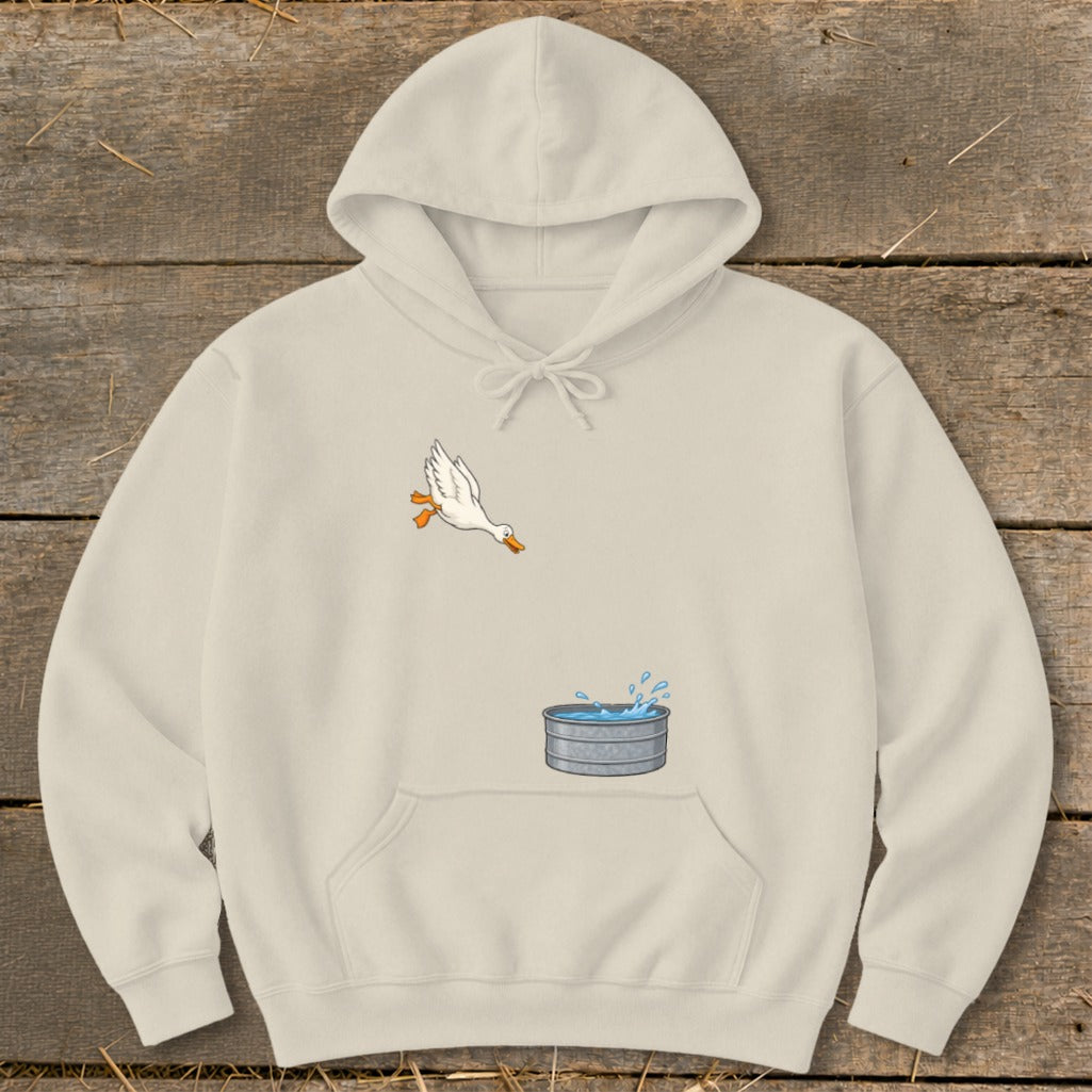 Cream hoodie with cartoon duck jumping into a galvanized tub of water.