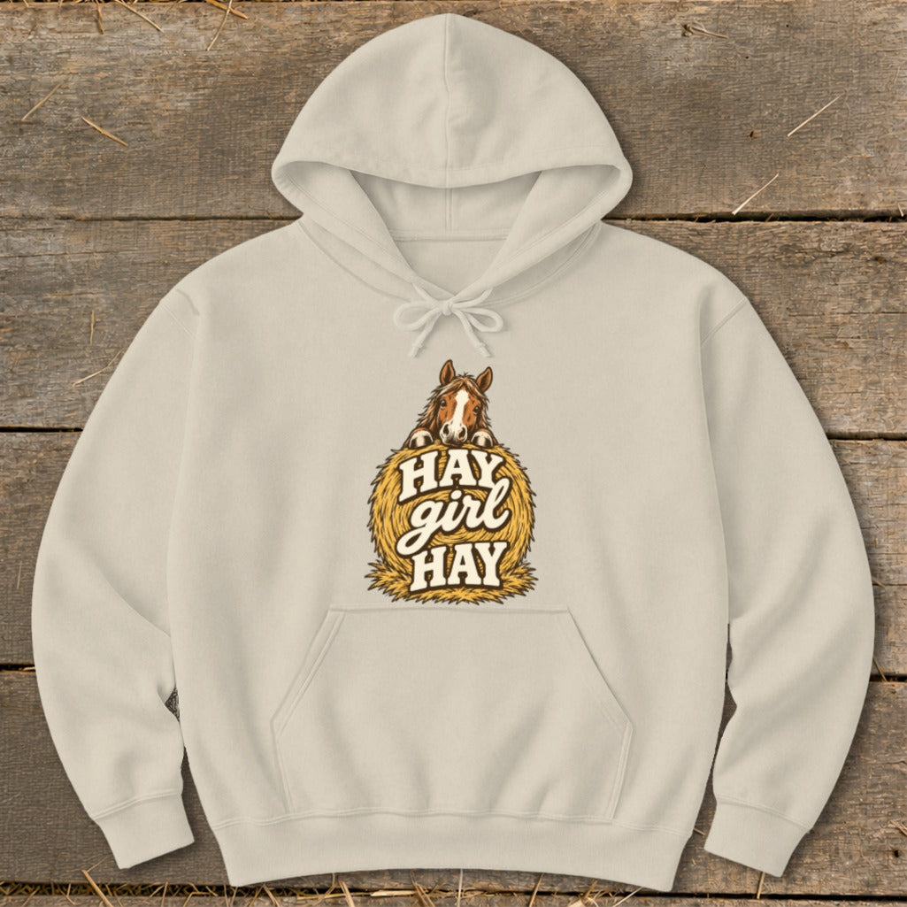 Cream hoodie with horse on hay bale graphic saying "Hay Girl Hay."