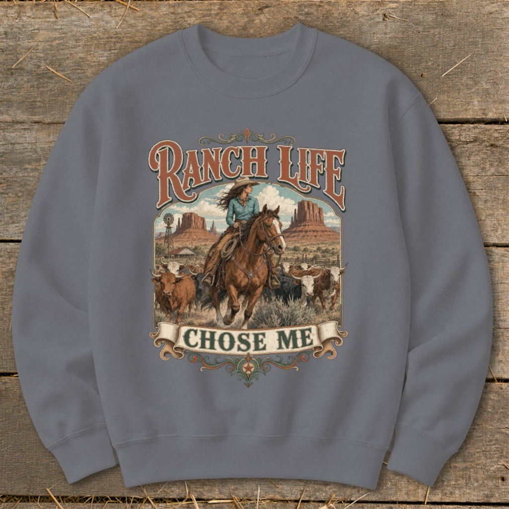 Sweatshirt with "Ranch Life Chose Me" text and a cowgirl on horseback herding cattle.