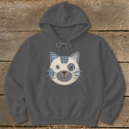 Dark gray hoodie with a patchwork cat face applique and buttons for eyes.