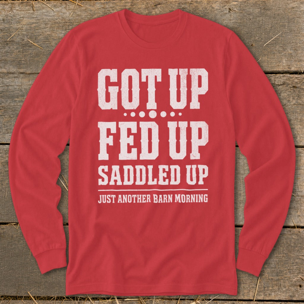 Red long-sleeve shirt with white text: GOT UP FED UP SADDLED UP JUST ANOTHER BARN MORNING.