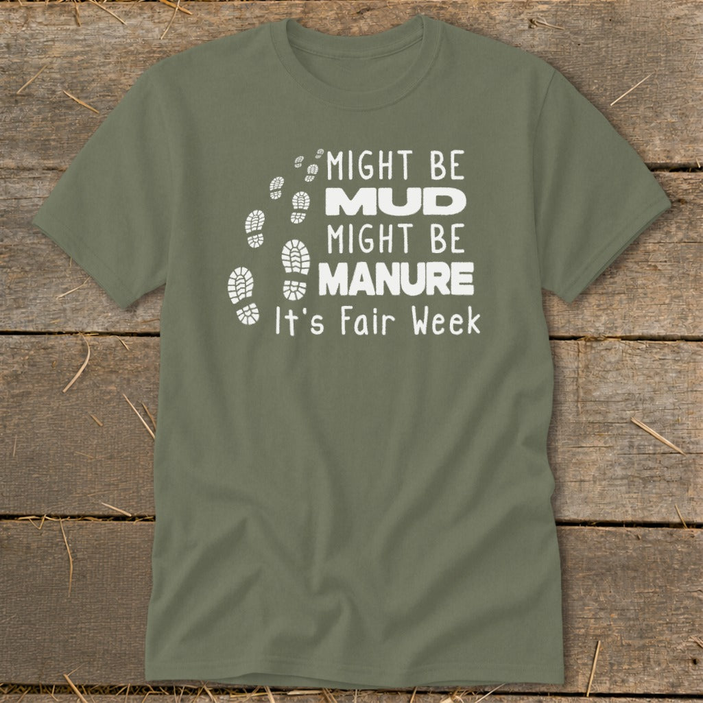 Green t-shirt with white text: "Might Be Mud, Might Be Manure, It's Fair Week."