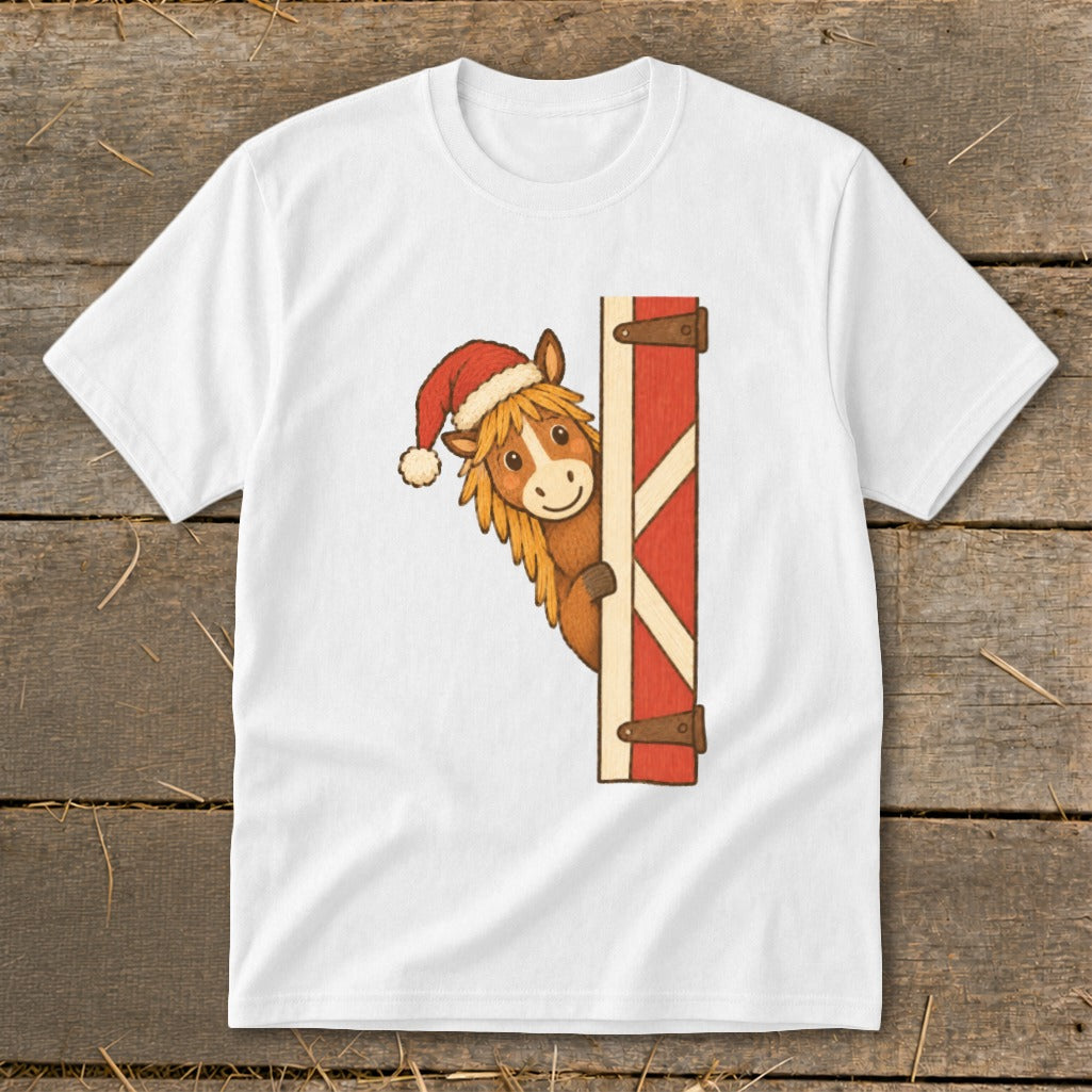 White t-shirt with a cartoon horse wearing a Santa hat peeking around a red barn door.