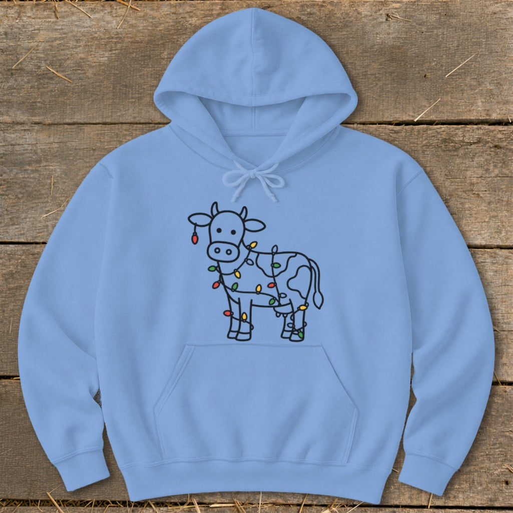 Light blue hoodie with a cartoon cow wrapped in colorful Christmas lights.