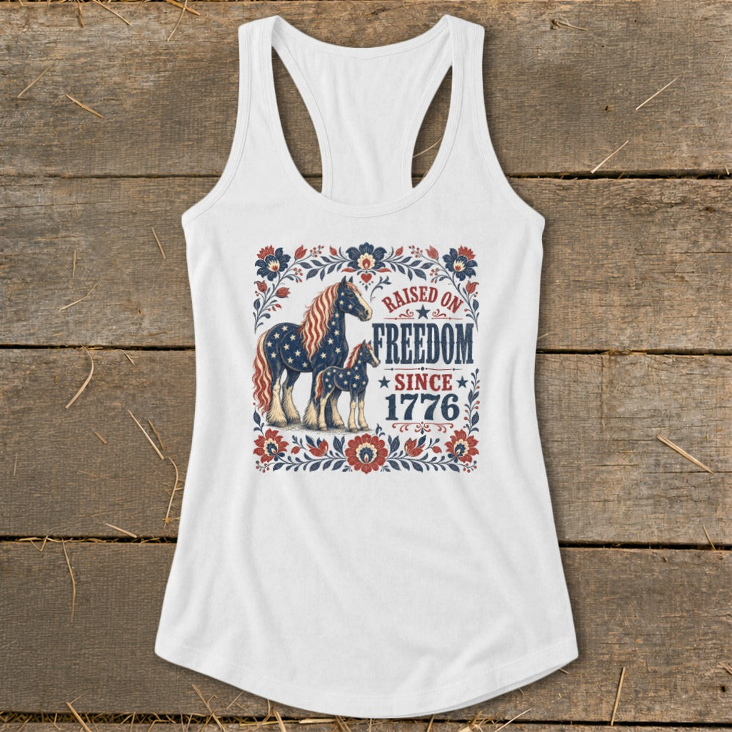 White tank top with patriotic horses and text "Raised on Freedom Since 1776".