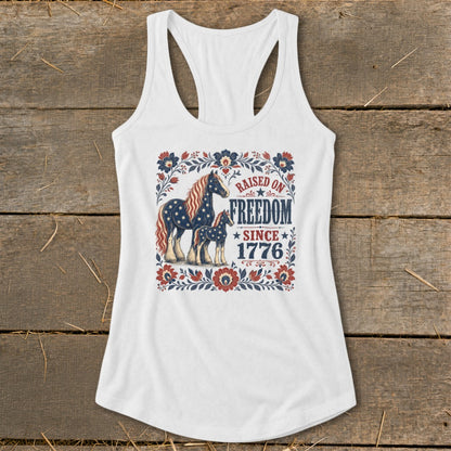 White tank top with patriotic horses and text "Raised on Freedom Since 1776".