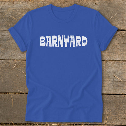 Royal blue crewneck t-shirt with rolled sleeves featuring distressed white text spelling BARNYARD on a wooden surface.
