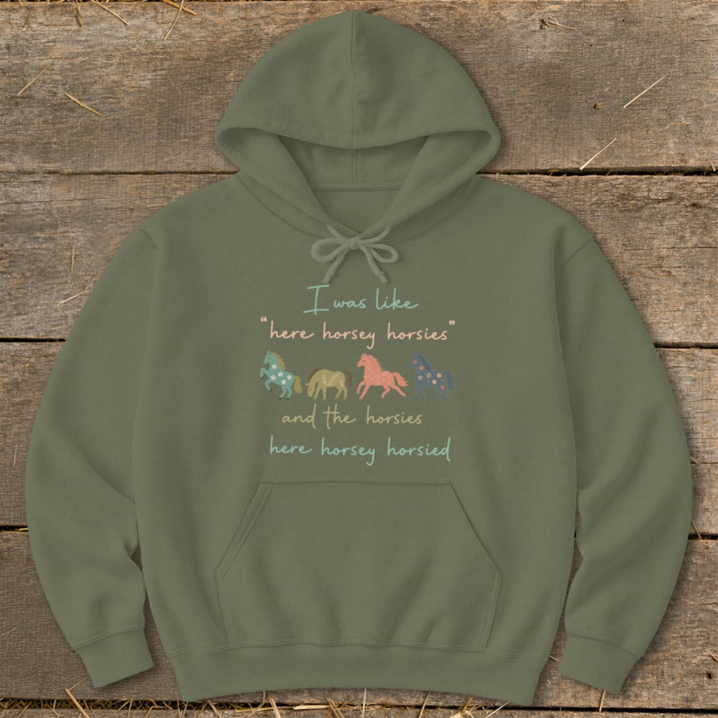 Olive green hoodie with text and four cartoon horses.