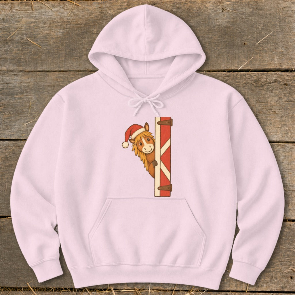 Pink hoodie with a cartoon horse wearing a Santa hat peeking from behind a gate.