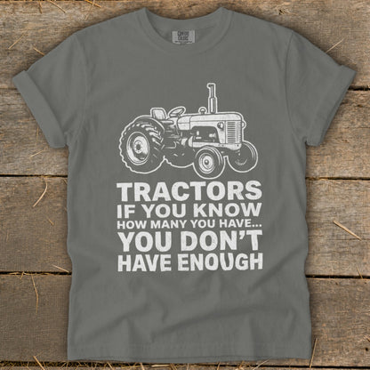 Gray t-shirt with a tractor graphic and text "Tractors if you know how many you have... You don't have enough".
