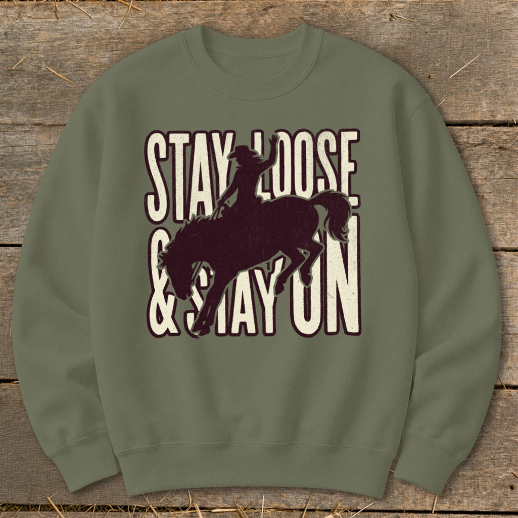 Green sweatshirt with a distressed graphic of a bronc rider and text "Stay Loose & Stay On."