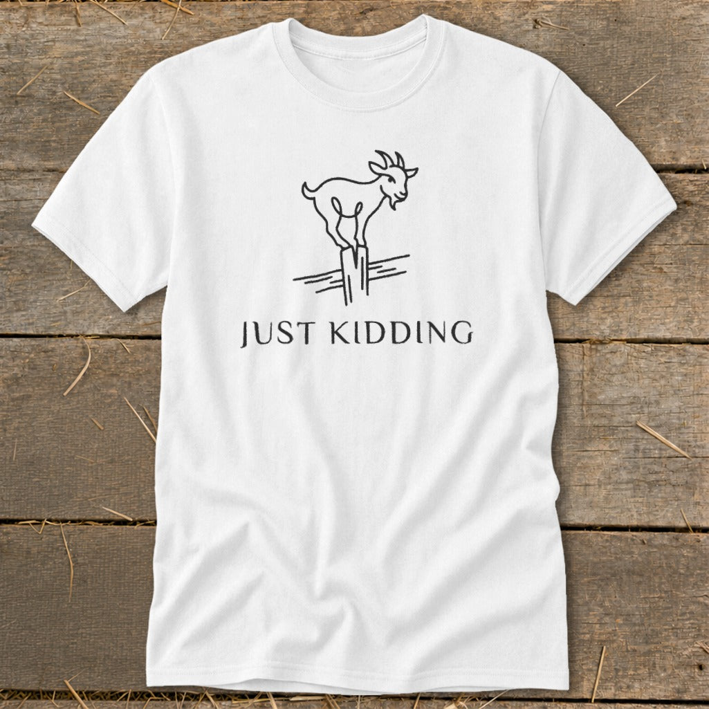 White t-shirt with a line drawing of a goat on a fence post and "JUST KIDDING" text.