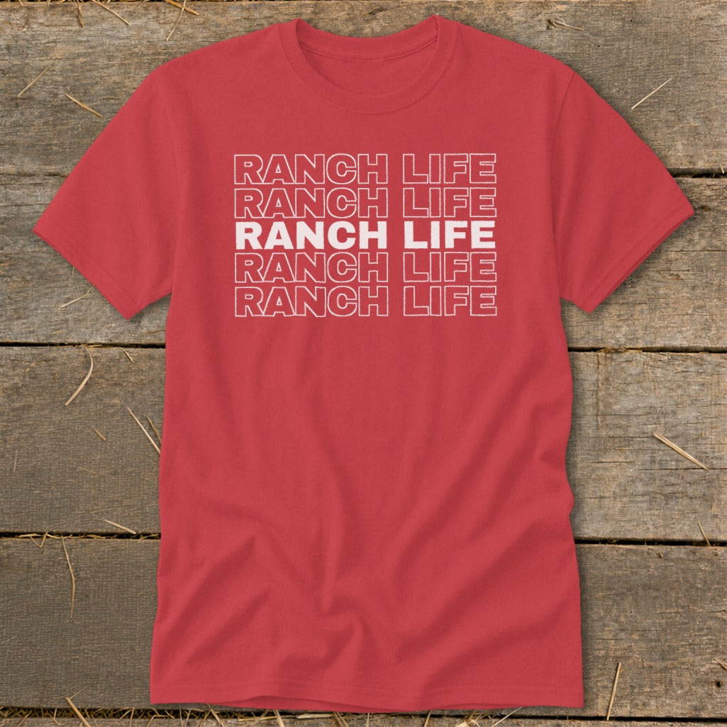 Red crewneck t-shirt featuring the stacked white text Ranch Life laid out against a rustic wooden background.