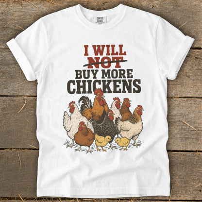 White t-shirt with "I Will Not Buy More Chickens" text and illustrations of chickens.