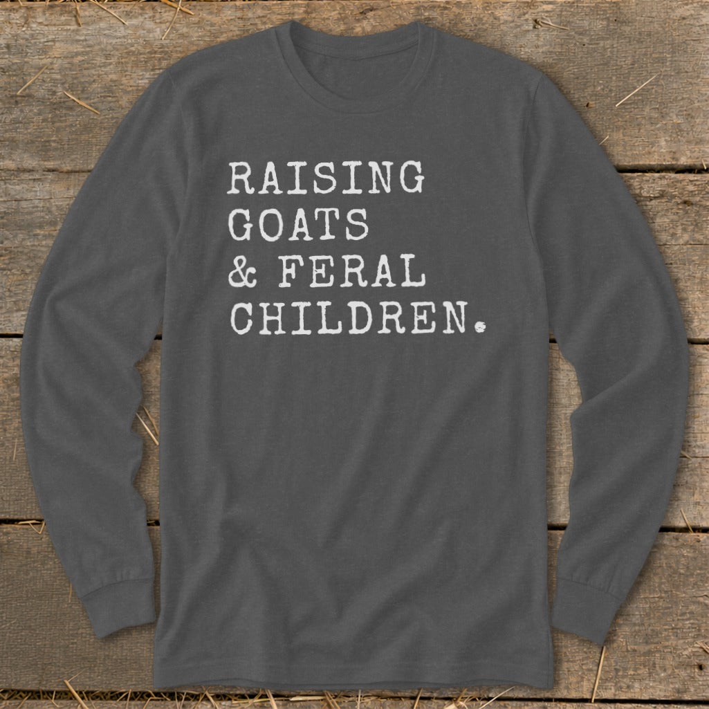 Dark grey long sleeve shirt with white text reading "RAISING GOATS & FERAL CHILDREN."