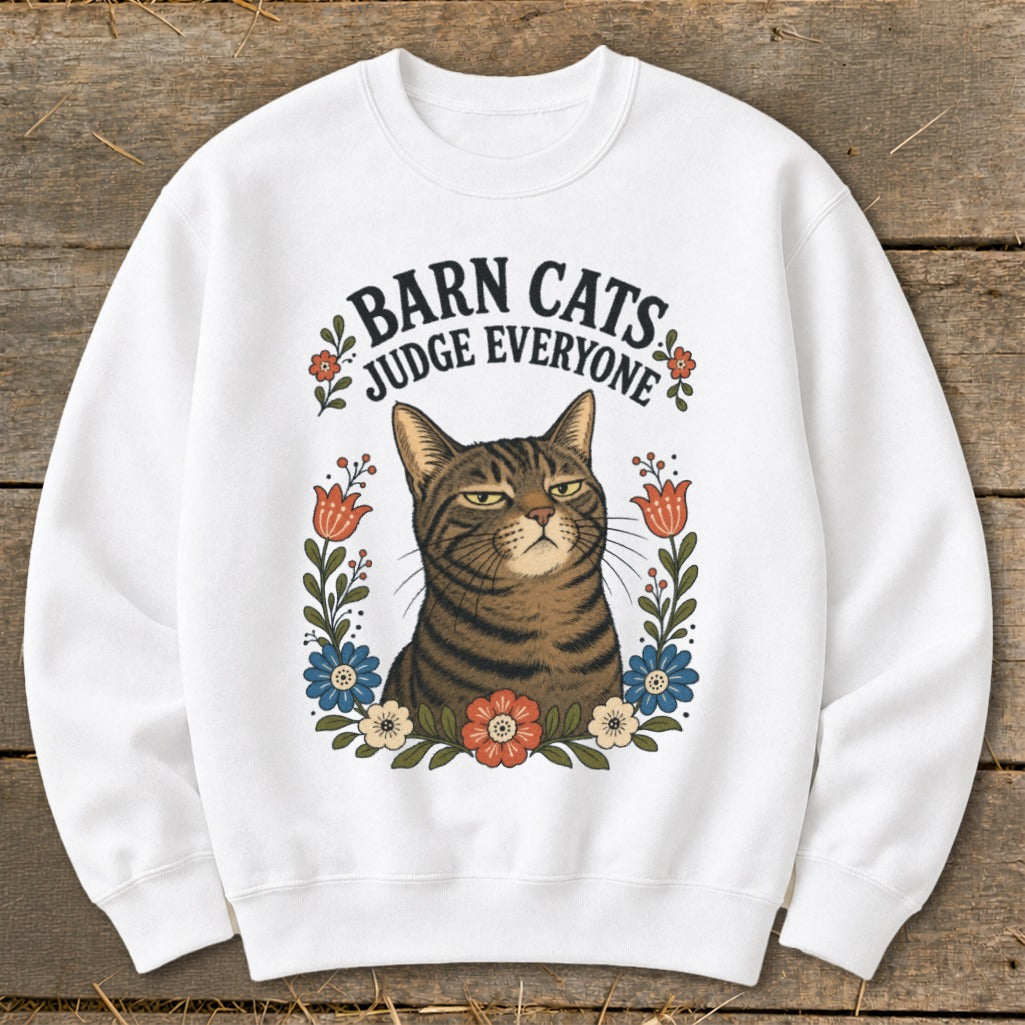 White sweatshirt with "Barn Cats Judge Everyone" text and a judgmental tabby cat surrounded by flowers.