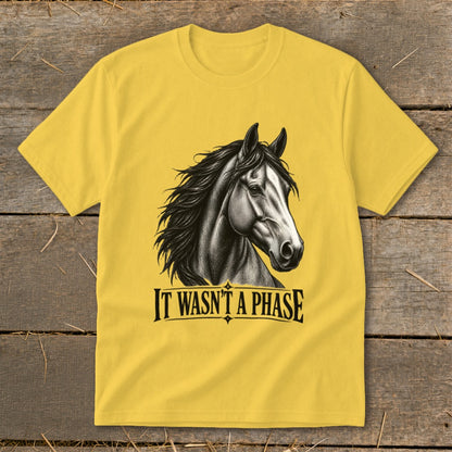 Yellow t-shirt with a black and white horse graphic and text "IT WASN'T A PHASE".