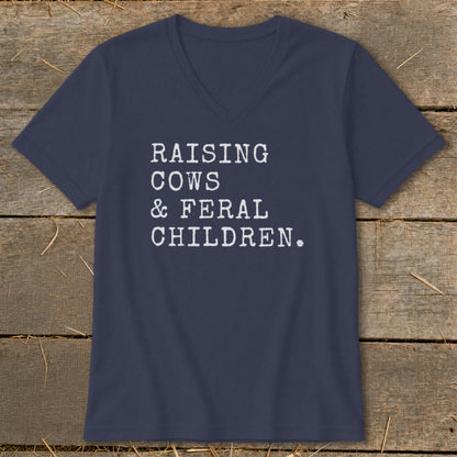 Navy v-neck t-shirt with white text reading "RAISING COWS & FERAL CHILDREN."