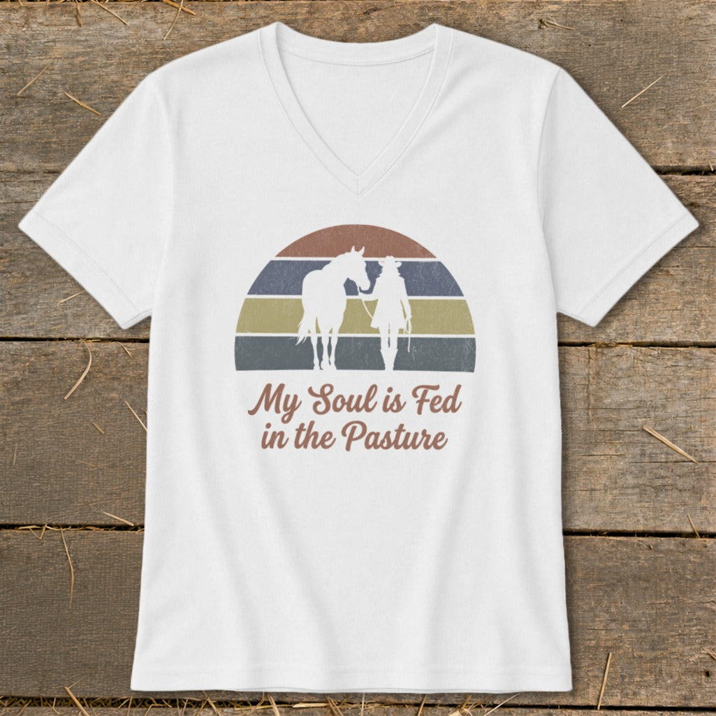 White v-neck t-shirt with horse and rider graphic and text.