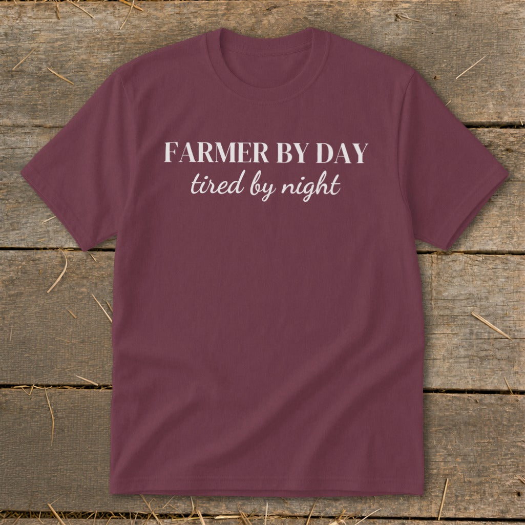Maroon t-shirt with white text reading "FARMER BY DAY tired by night".