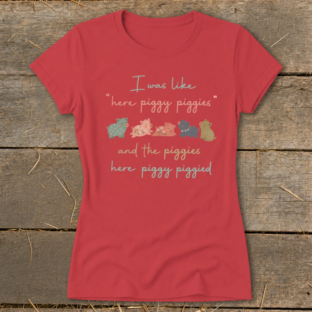 Red t-shirt with "I was like 'here piggy piggies' and the piggies here piggy piggied" and five cartoon pigs.