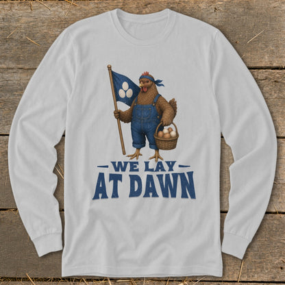 Chicken in overalls holding flag and basket of eggs with text "We Lay At Dawn".