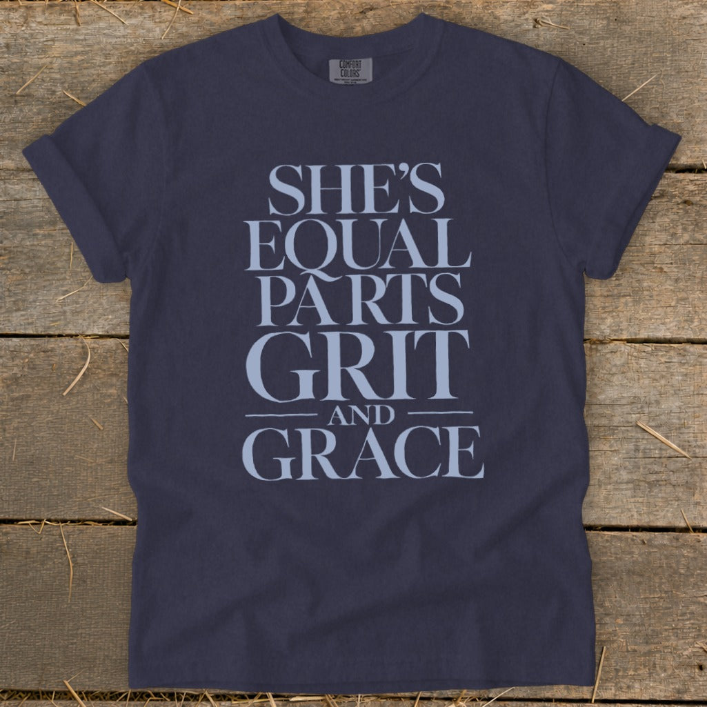 Navy t-shirt with "She's Equal Parts Grit and Grace" printed in light blue text.
