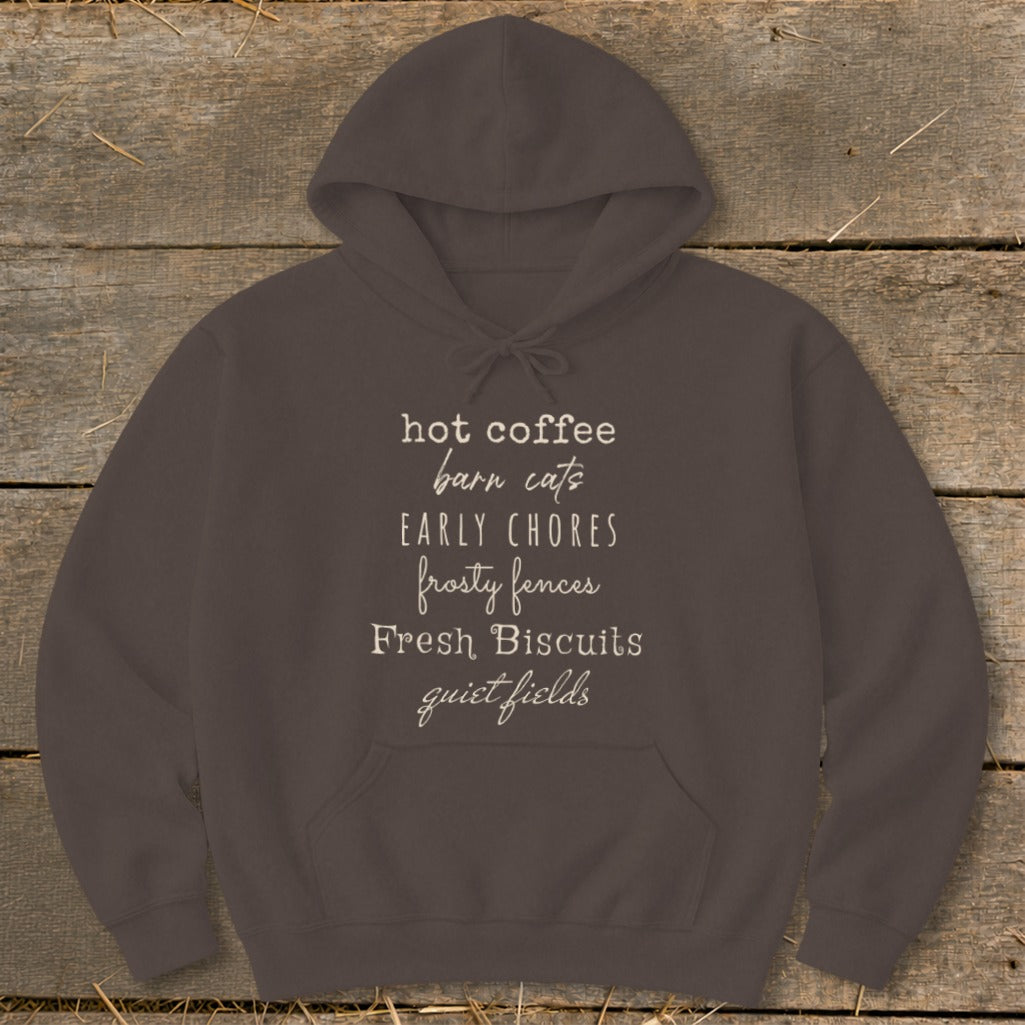 Brown hoodie with text listing: hot coffee, barn cats, early chores, frosty fences, fresh biscuits, quiet fields.