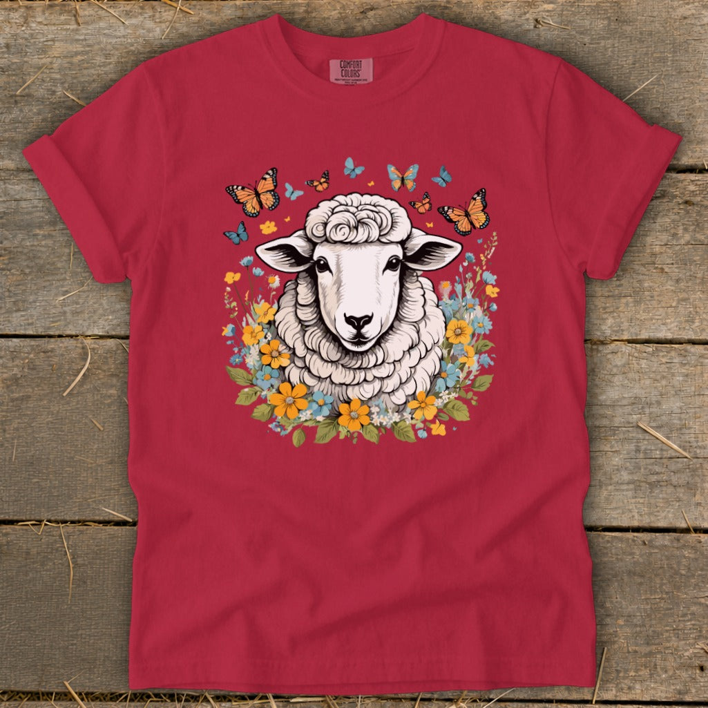Red t-shirt with sheep, butterflies, and floral graphic.