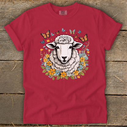 Red t-shirt with sheep, butterflies, and floral graphic.