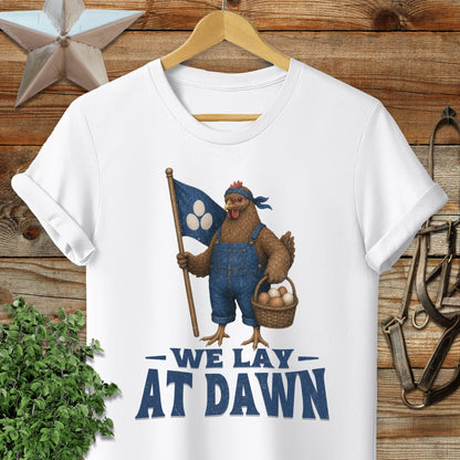 White t-shirt with distressed graphic of a chicken holding a flag and basket, reads "We Lay At Dawn".