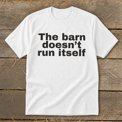 White t-shirt with black text reading "The barn doesn't run itself".