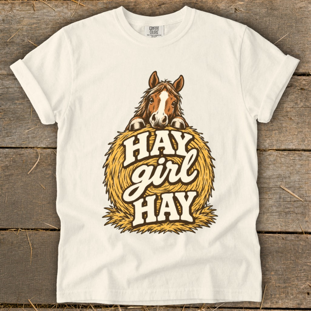 White t-shirt with a horse peeking over a hay bale, saying "HAY girl HAY".