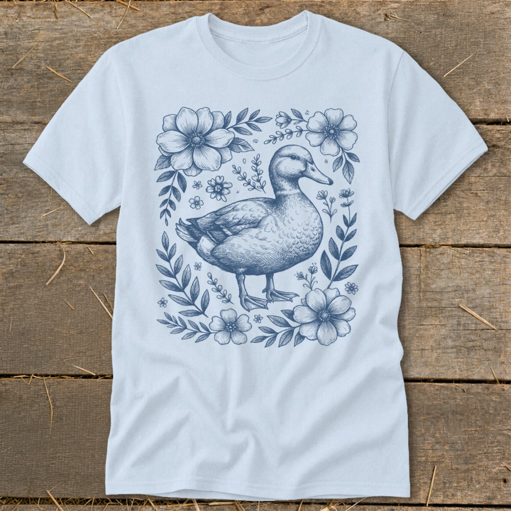 Light blue t-shirt with a dark blue floral border and a duck illustration.