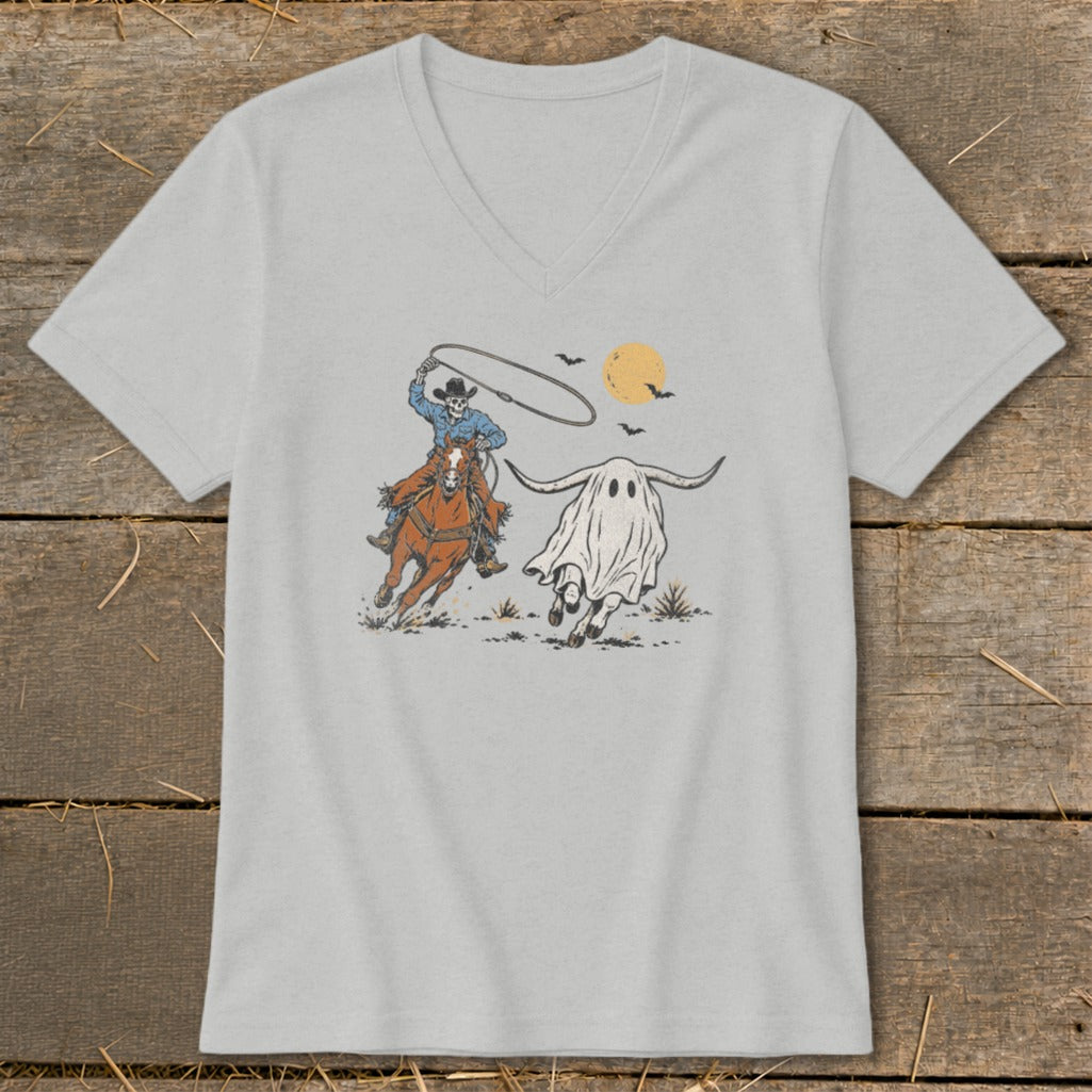 Skeleton cowboy on horse lassoing a ghost with long horns under a moon.