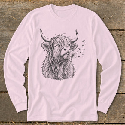 Long sleeve t-shirt with a sketch of a fluffy Highland cow blowing on a dandelion.