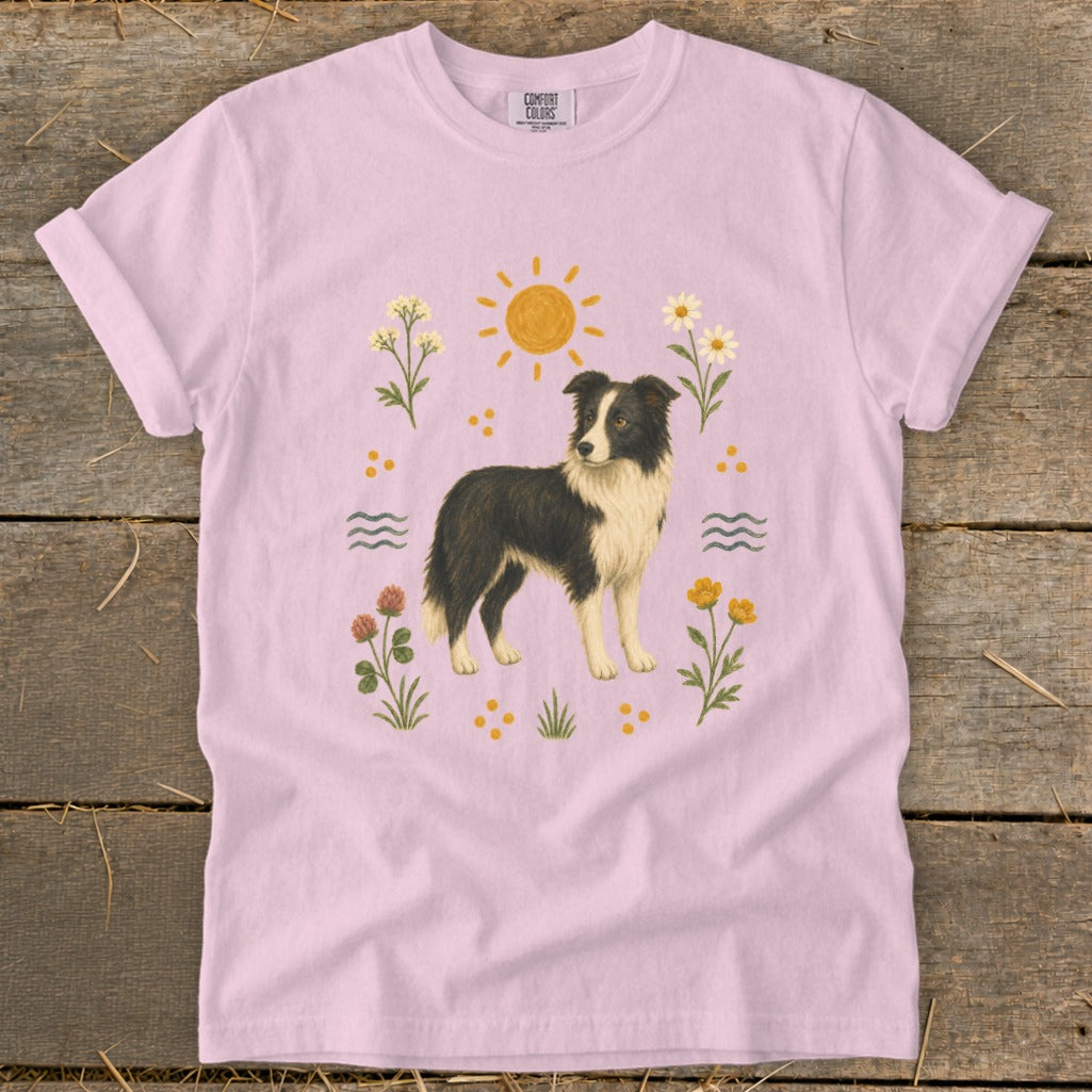 Pink t-shirt with border collie dog and floral sun graphic.