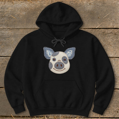 Black hoodie with a patchwork pig face applique on the chest.