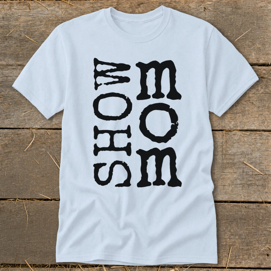 Light blue t-shirt with bold black text "MOM" vertically stacked next to "SHOW".