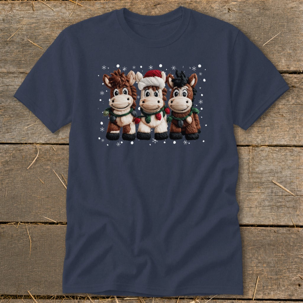 Three cartoon horses in Christmas decorations and Santa hat with snow falling.