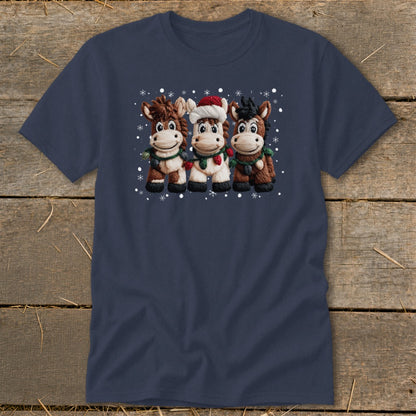 Three cartoon horses in Christmas decorations and Santa hat with snow falling.